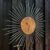 wall clock made using upcyled bicycle spokes, chian and nipples in a sunburst design